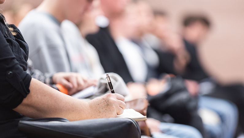 Teachers sitting in forum setting